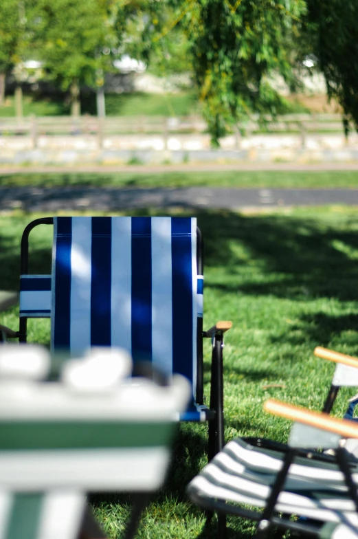 blue and white striped chairs in the grass