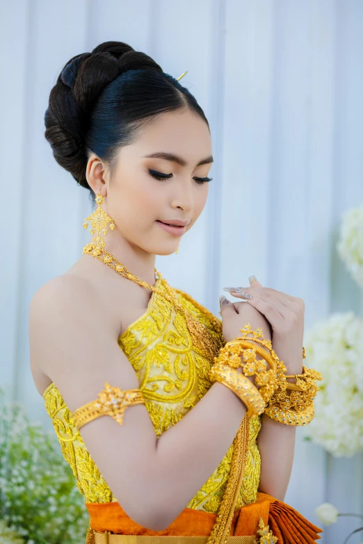 a young woman wearing a costume holding a gold ring