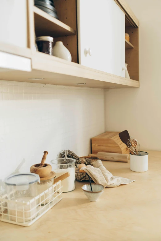 a kitchen counter with wooden utensils and plates