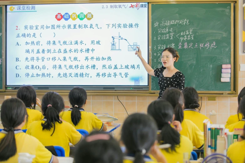 a woman giving an english language lesson to children