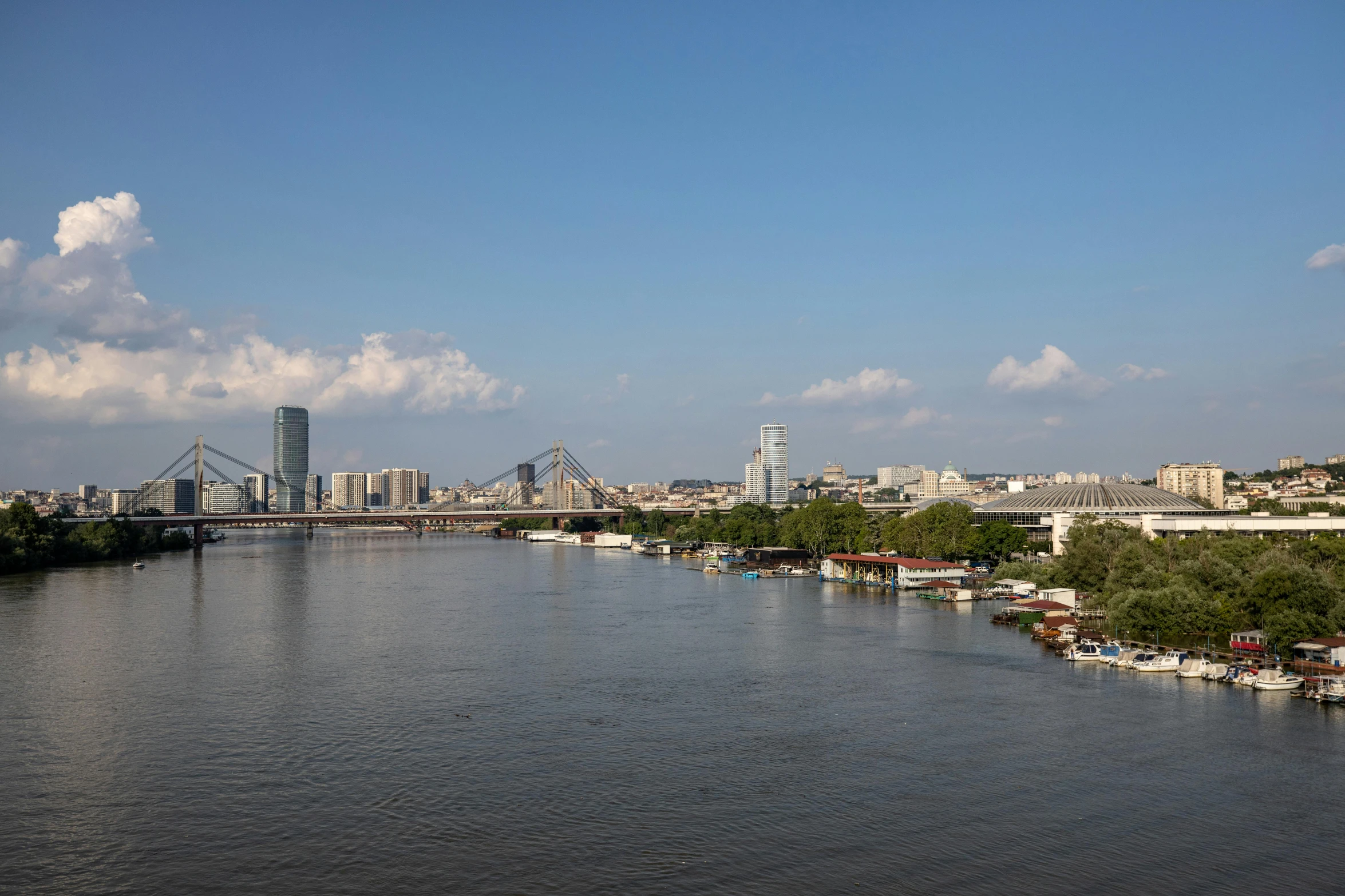 a large body of water near buildings on the shoreline