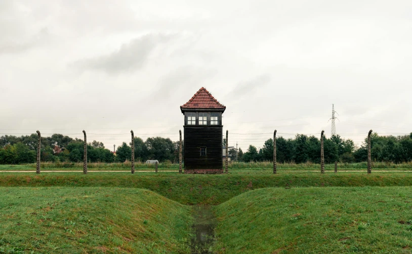 a small tower near some trees and grass