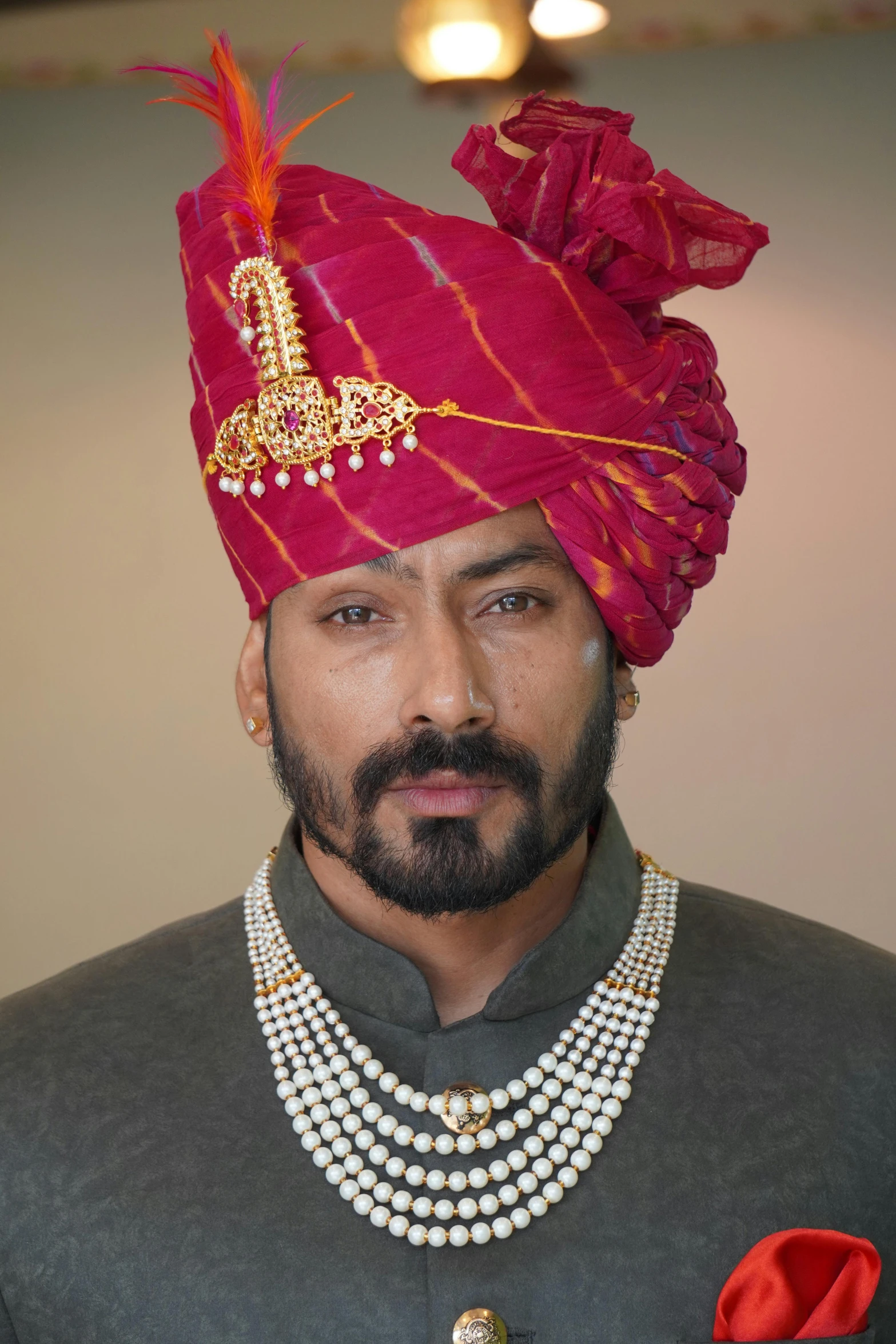 man wearing a red hat and pearl necklace