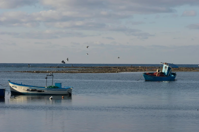 two boats are sitting in a shallow body of water