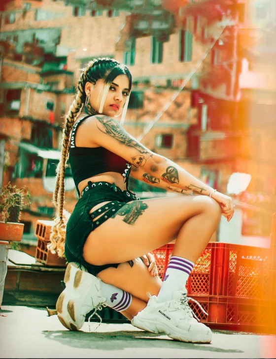 a female wearing short shorts and an ear piercing sitting down