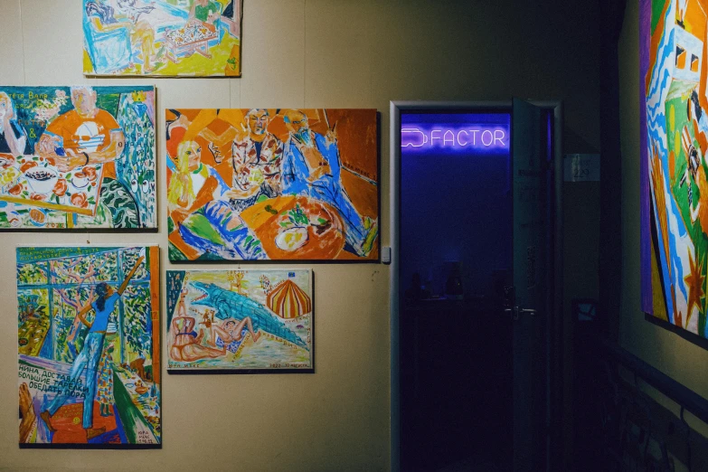 there are multiple paintings mounted on the wall