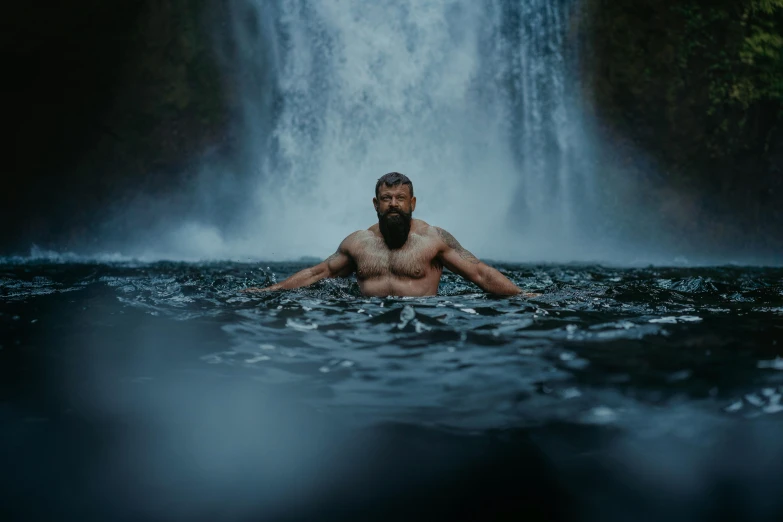 a man is sitting on his knees in the water