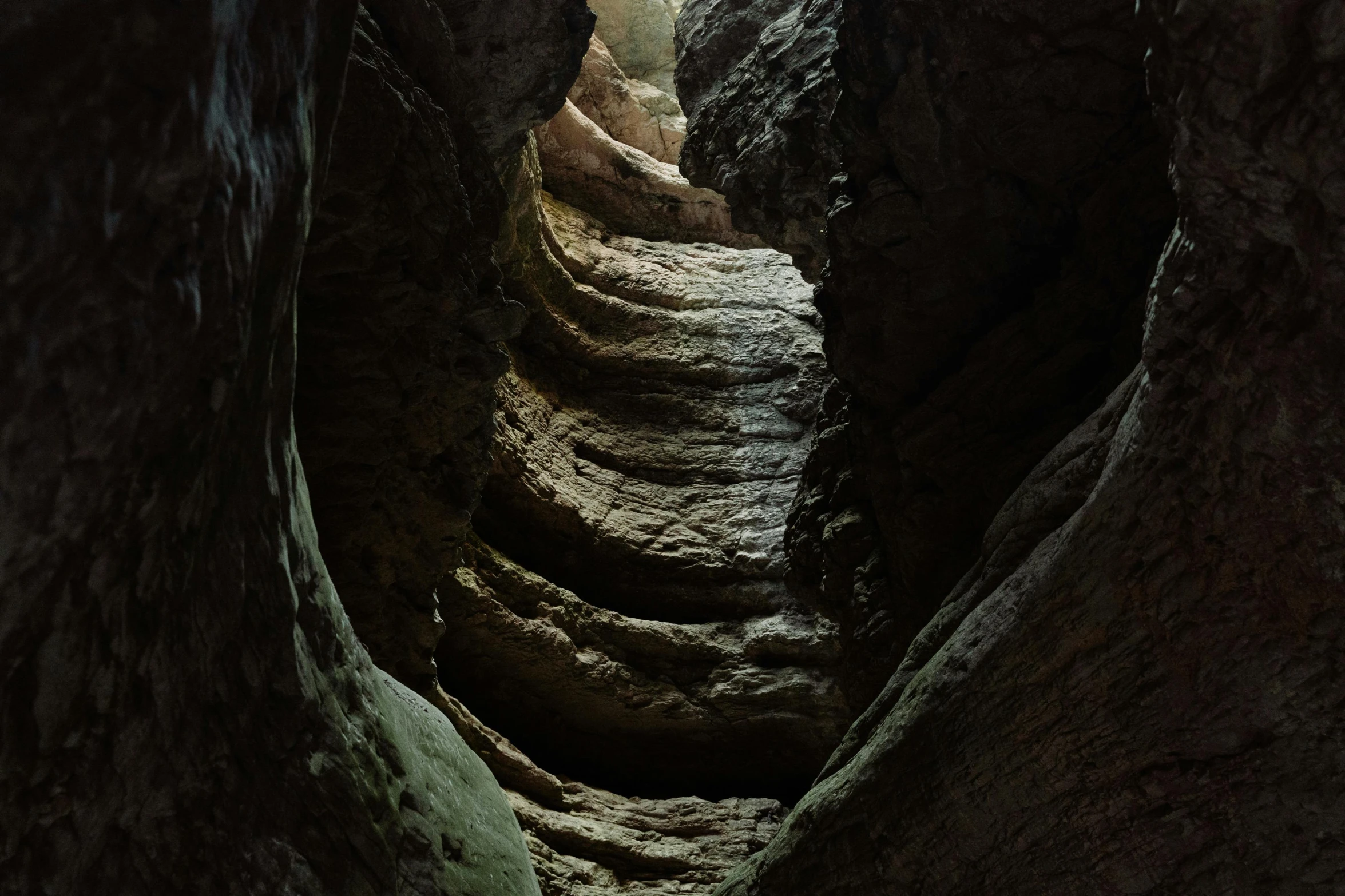 inside a narrow rocky path with many narrow, rock stairs