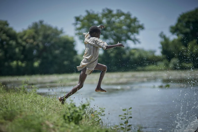 a  playing with a disc near a lake