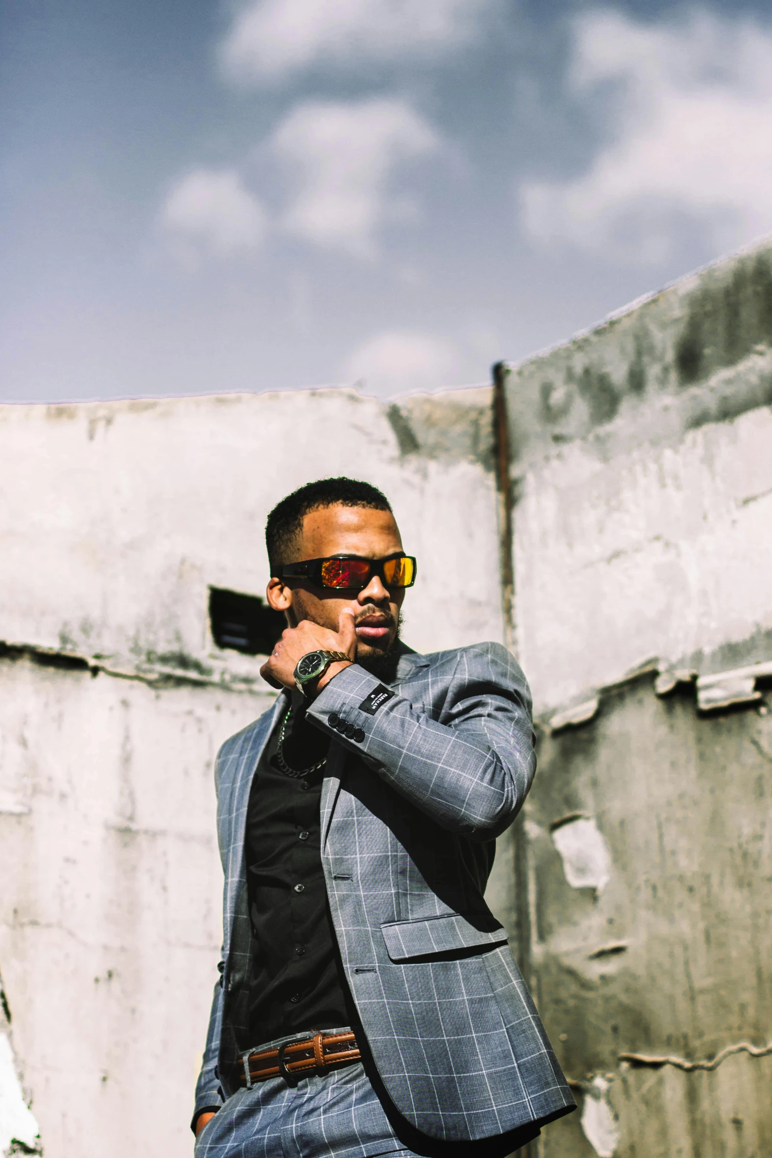 a man in a suit and glasses talks on his cell phone