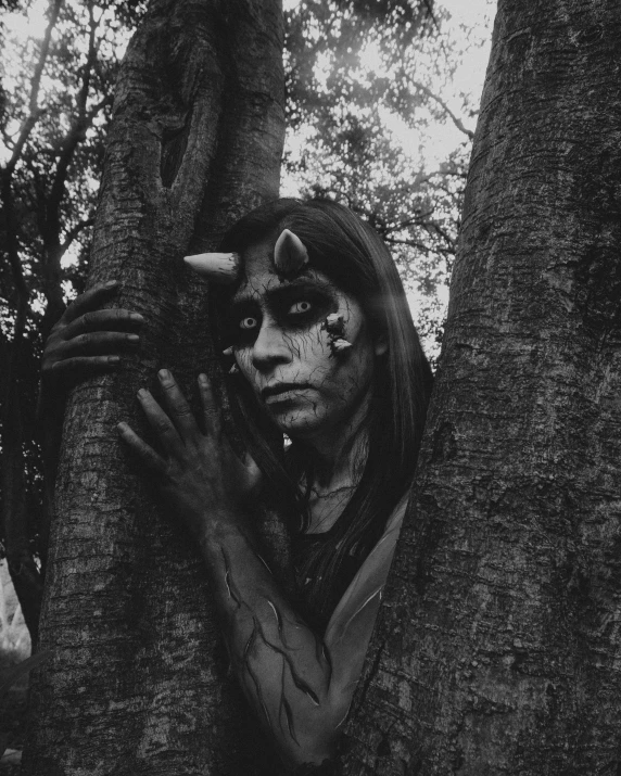 a man standing in the middle of a forest