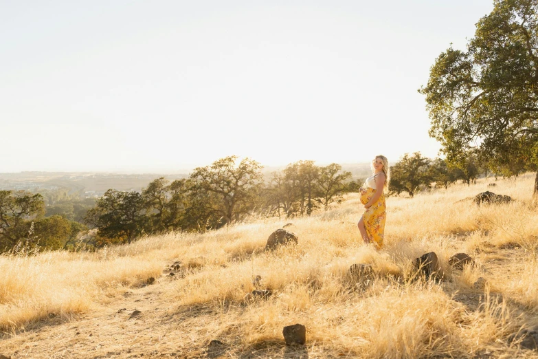 a woman walking down a path in a golden field