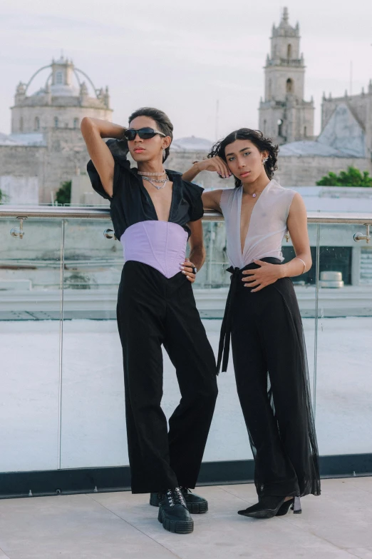 a couple of people standing on top of a roof