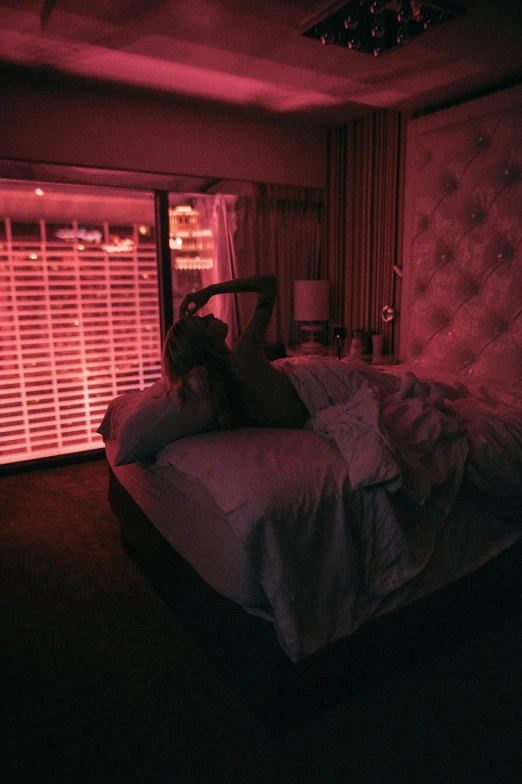 an empty bed with a red light in a room