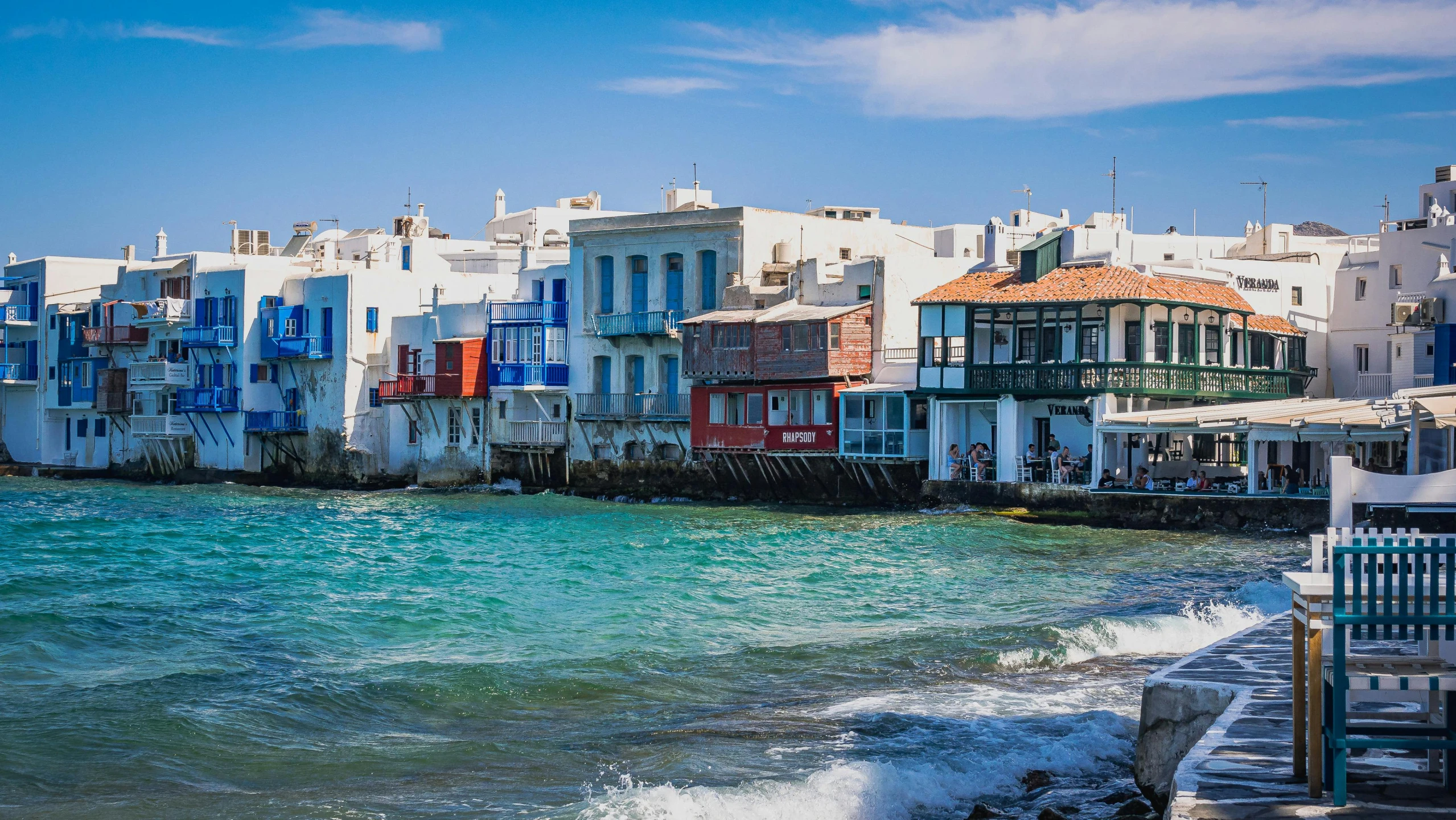 some white houses a body of water and some buildings