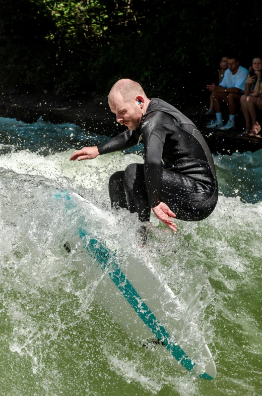 a man on a surf board jumping over a wave