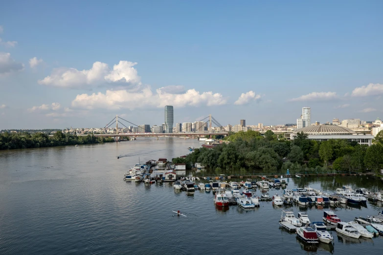 boats on a large body of water in front of a city