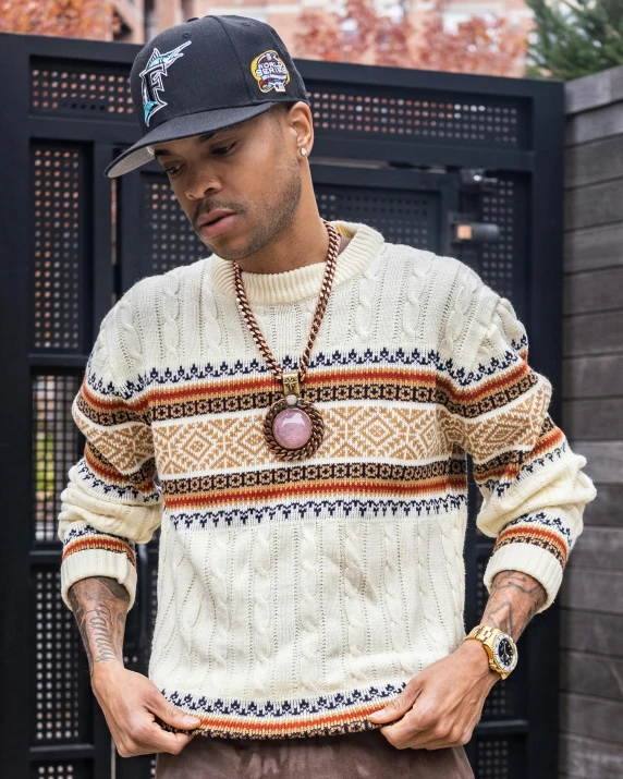 a man is looking at his watch while wearing a hat