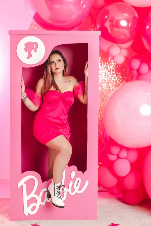 a woman posing in a po frame with balloons