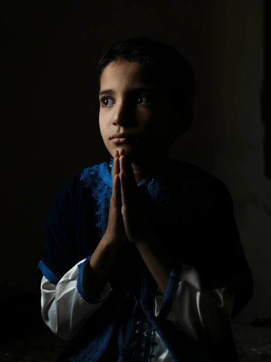 a  dressed in medieval clothing is praying