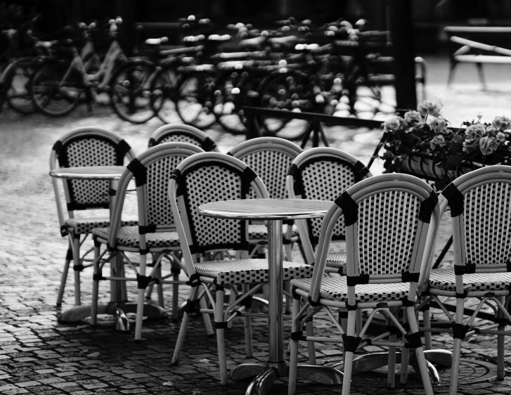 several chairs sitting around a table and bicycle rack