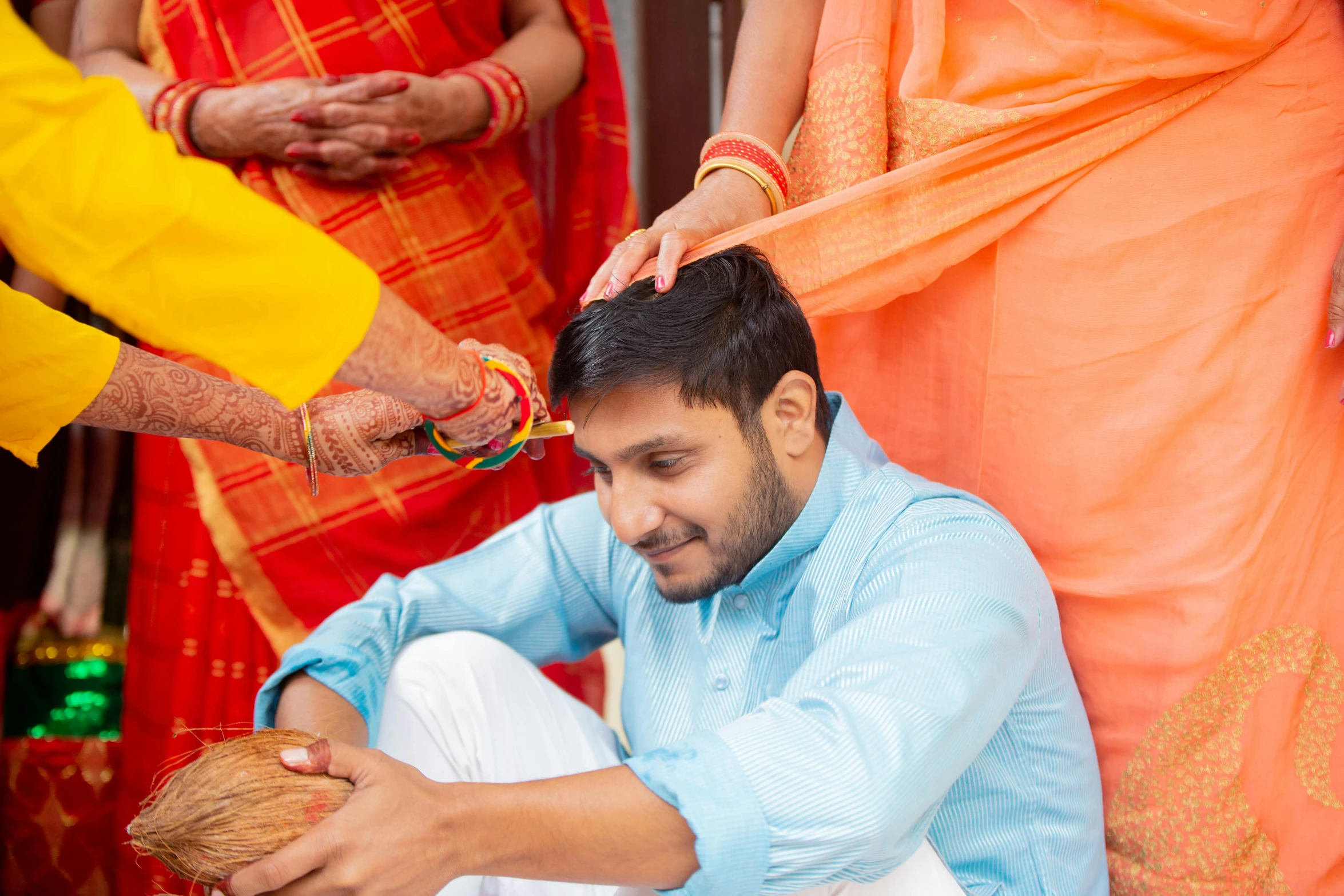 groom getting ready to cut hair with other people nearby