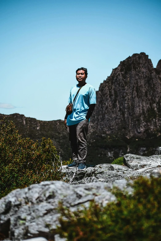 a man standing on the edge of a rocky cliff