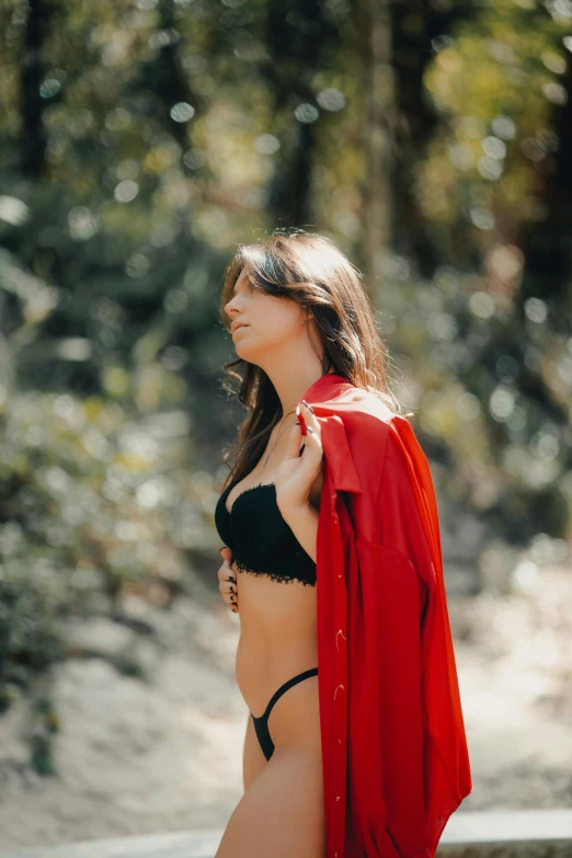 a woman posing for a picture with her cape around her neck