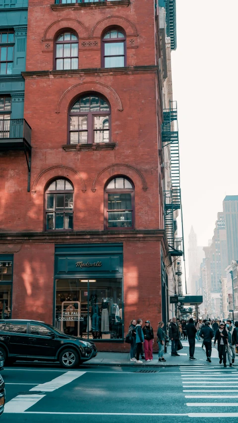 a group of people standing next to each other on the street