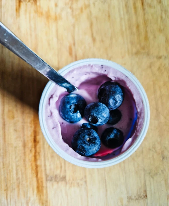 the blueberries and yogurt is in a plastic bowl