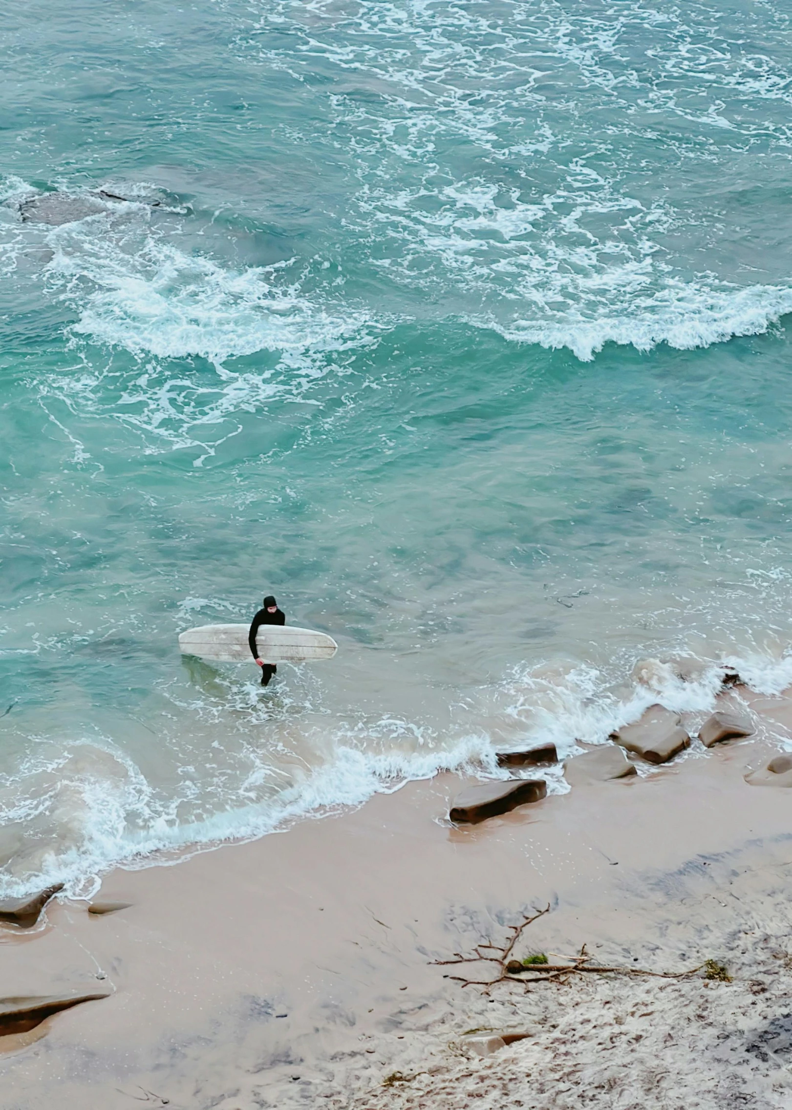 a duck swimming across a surf board into the ocean