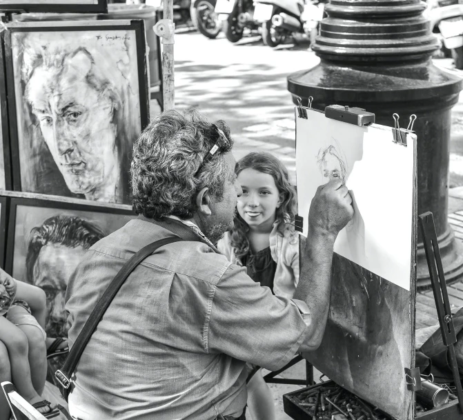 a woman painting with two young children sitting in front of her