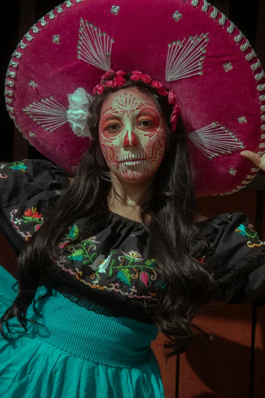 a woman in mexican costumes poses for a po