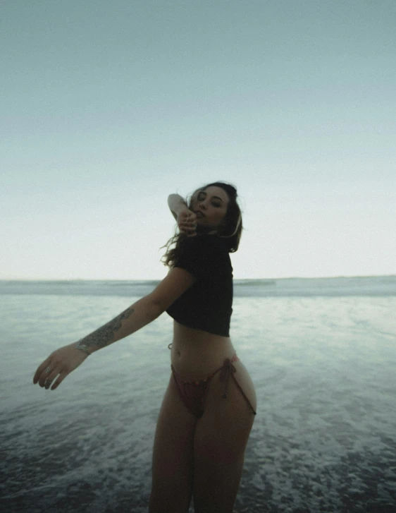 a women who is standing in the sand