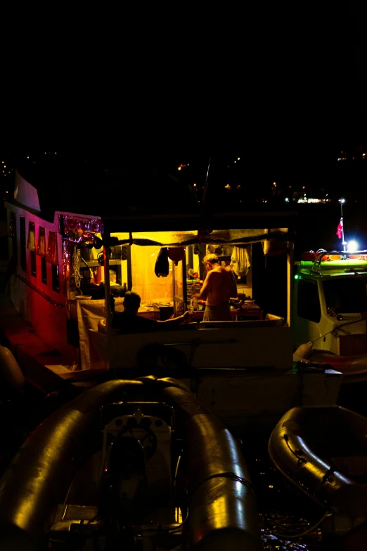 a boat with lights in the back lit up at night