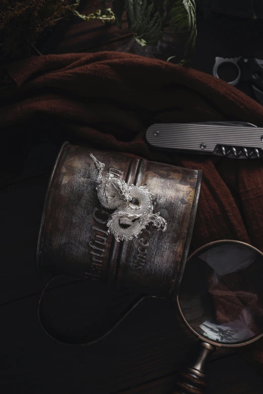 an old antique purse and magnifying glass on a dark wooden floor