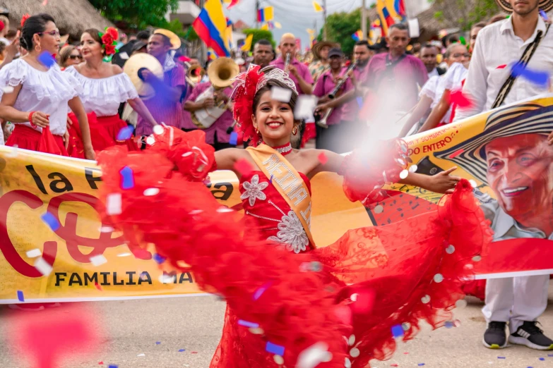 woman in red dressed in traditional spanish dress dancing on stage