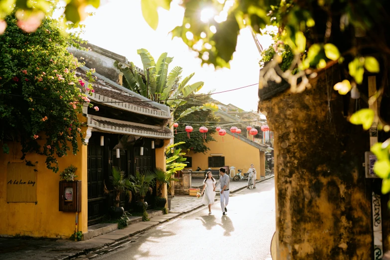 a man and woman are walking down a narrow street