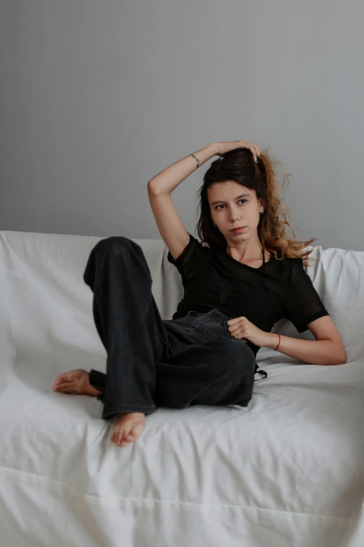 young lady laying on the bed in black clothes