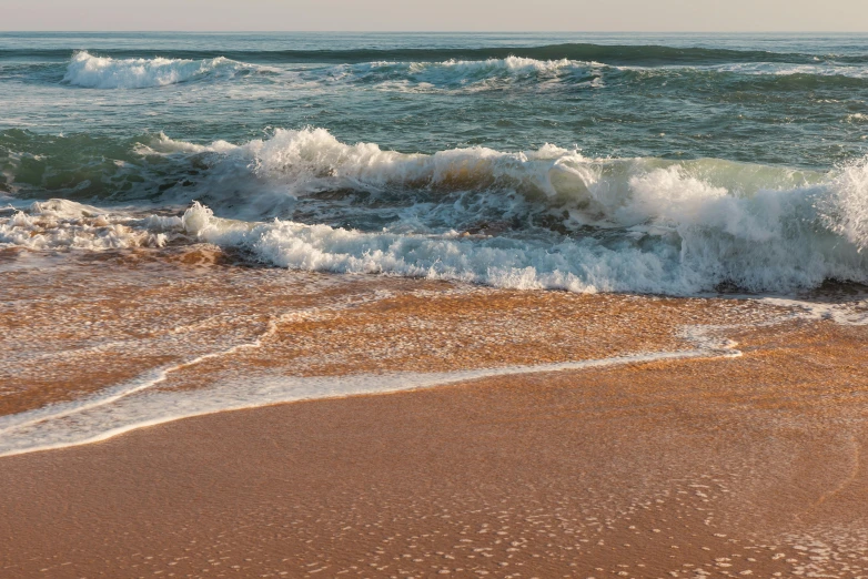 the water has washed onto the sand by the waves