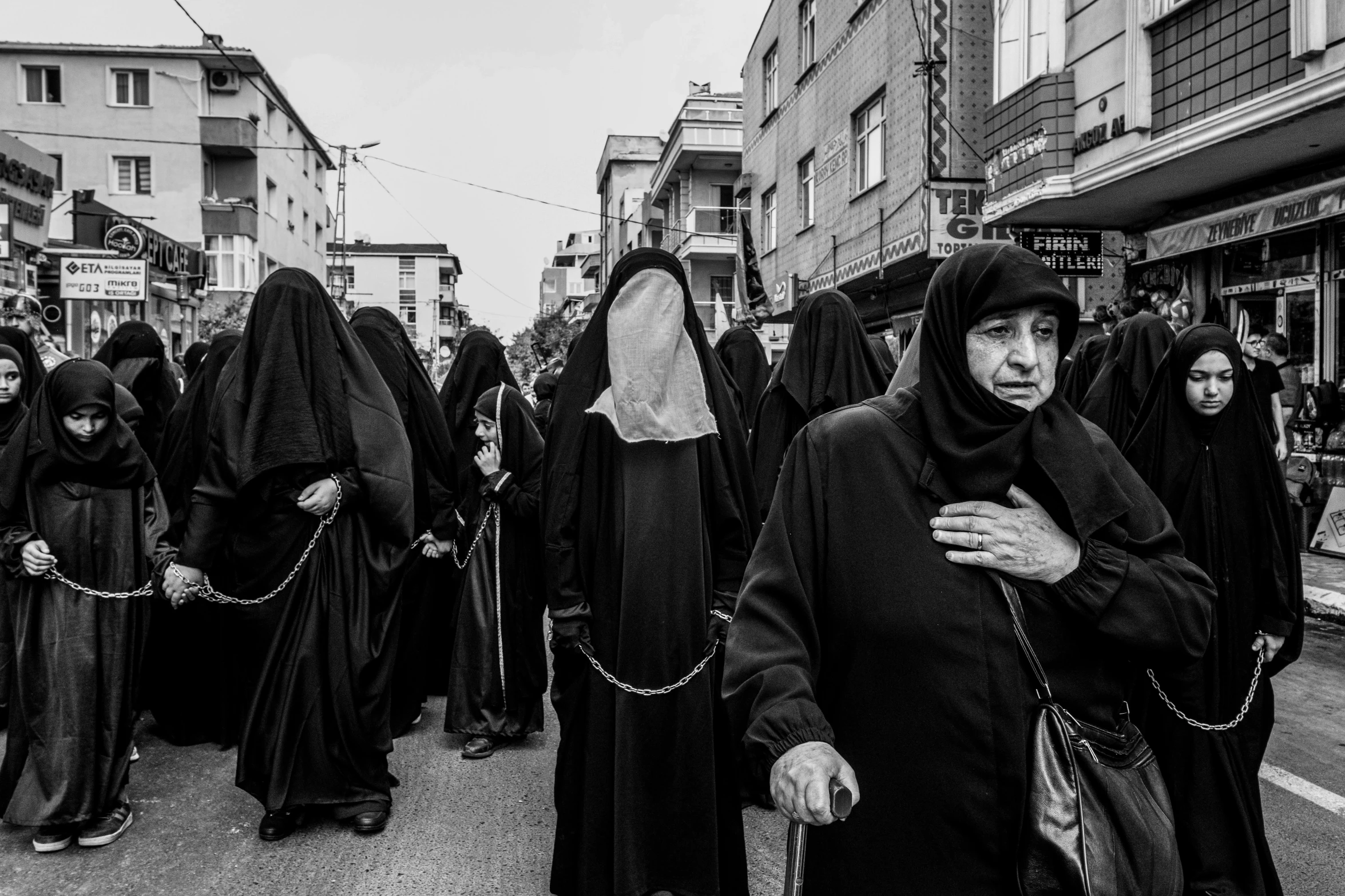 a group of people are walking down a street