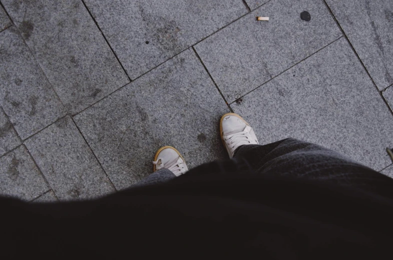 the feet of a person standing on top of a floor