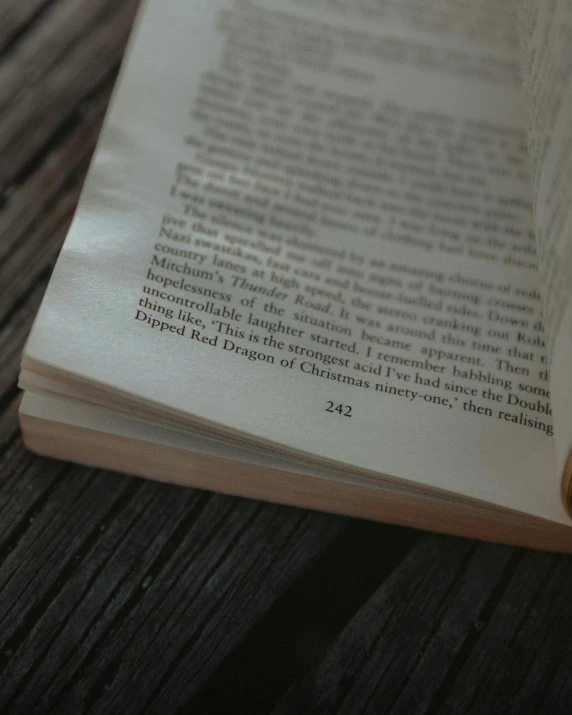 an open book laying on top of a wooden table