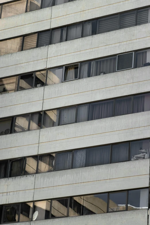 windows are seen in the side of an office building