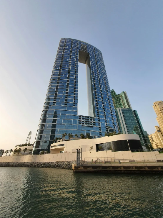 a boat floating in front of two tall buildings