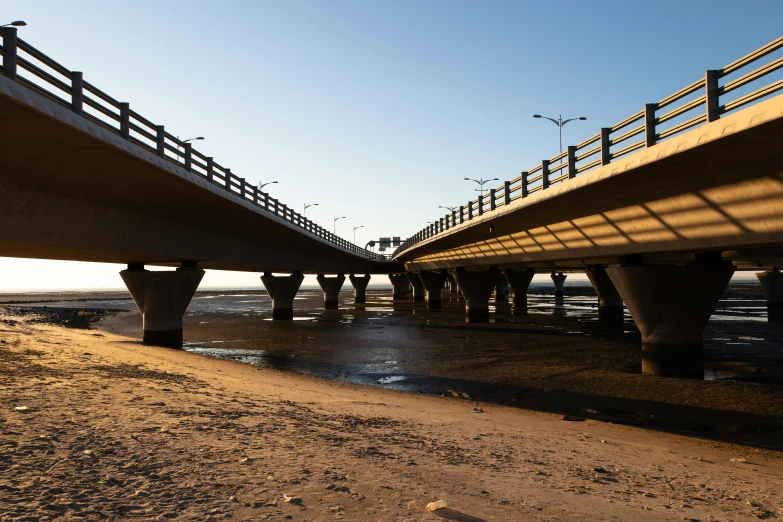 a picture under an overpass next to the beach