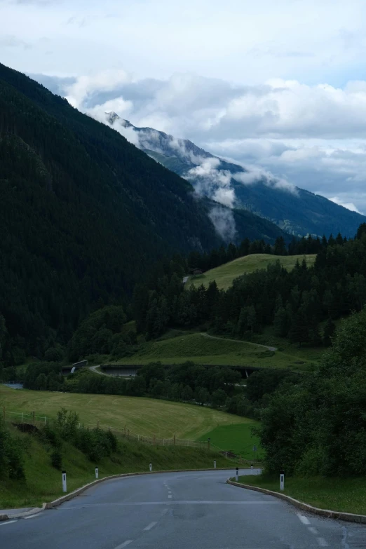 there is a mountain range with mountains and clouds coming in