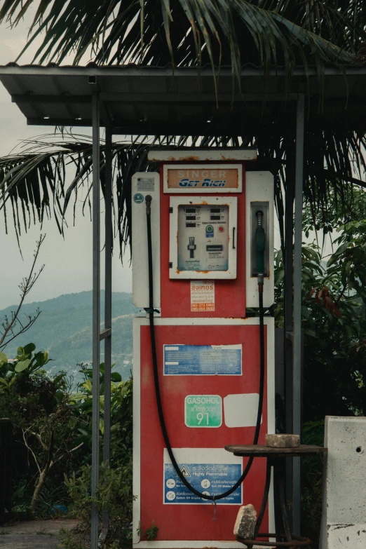 an old fashioned fuel pump attached to a house