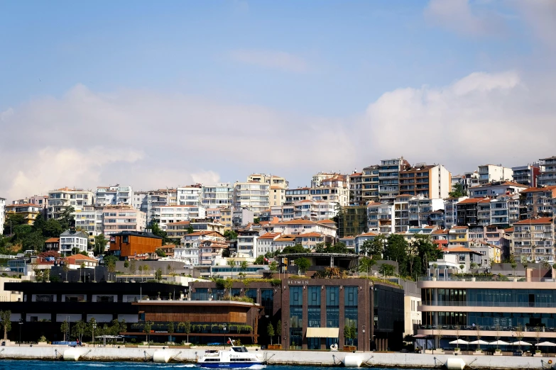 the city is on the edge of water with sailboats in front