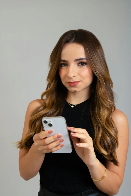 a woman in black top looking at a cell phone